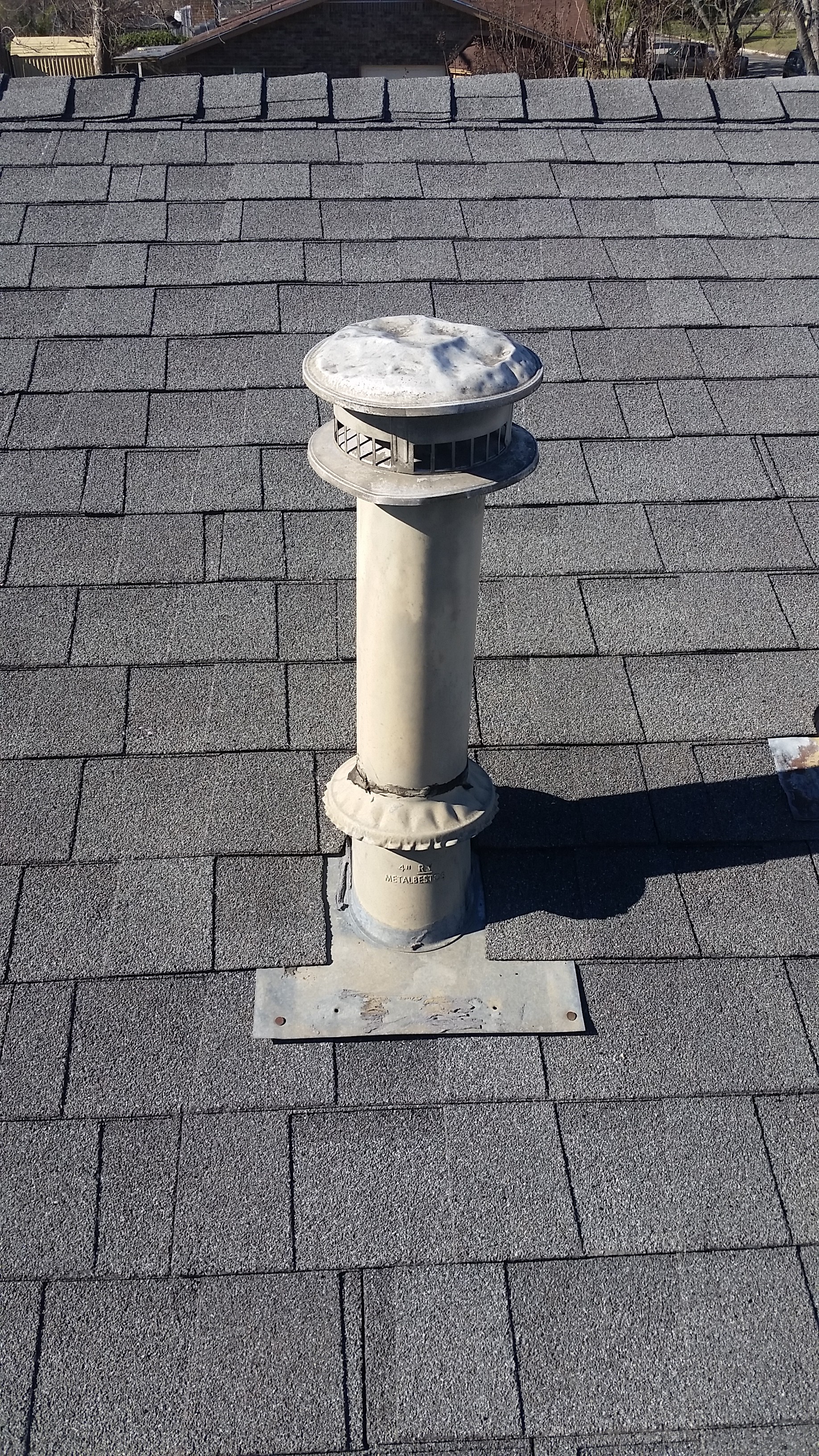 Roof vent pipe boot on asphalt shingle roof — Heritage Roofing ventilation service