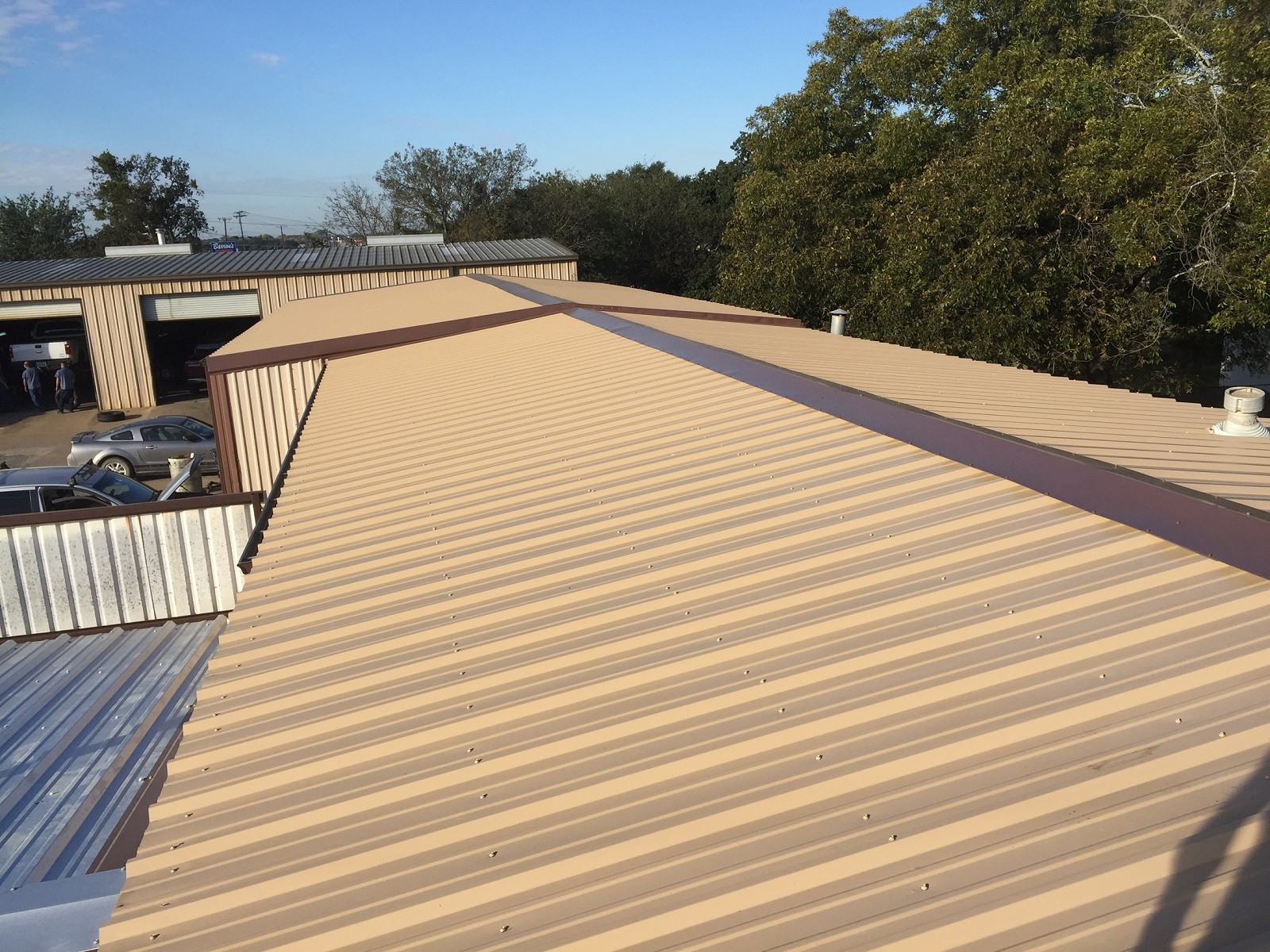 Commercial metal panel roof installation on industrial building in Central Texas — Heritage Roofing